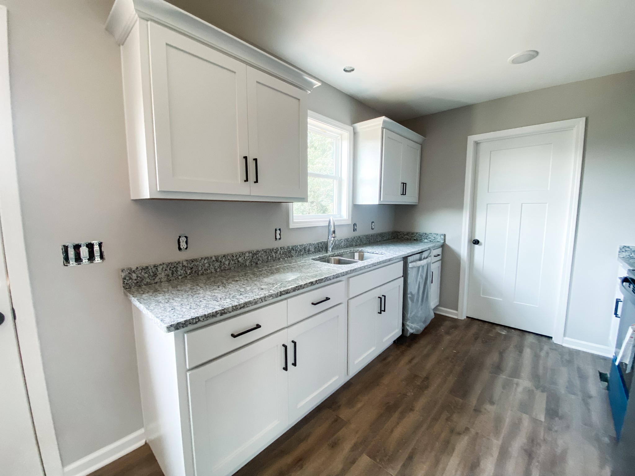 372 Calvert Ridge Road Westmoreland, TN 37186 - Photo 3 of 13 a kitchen with granite countertop white cabinets and white appliances