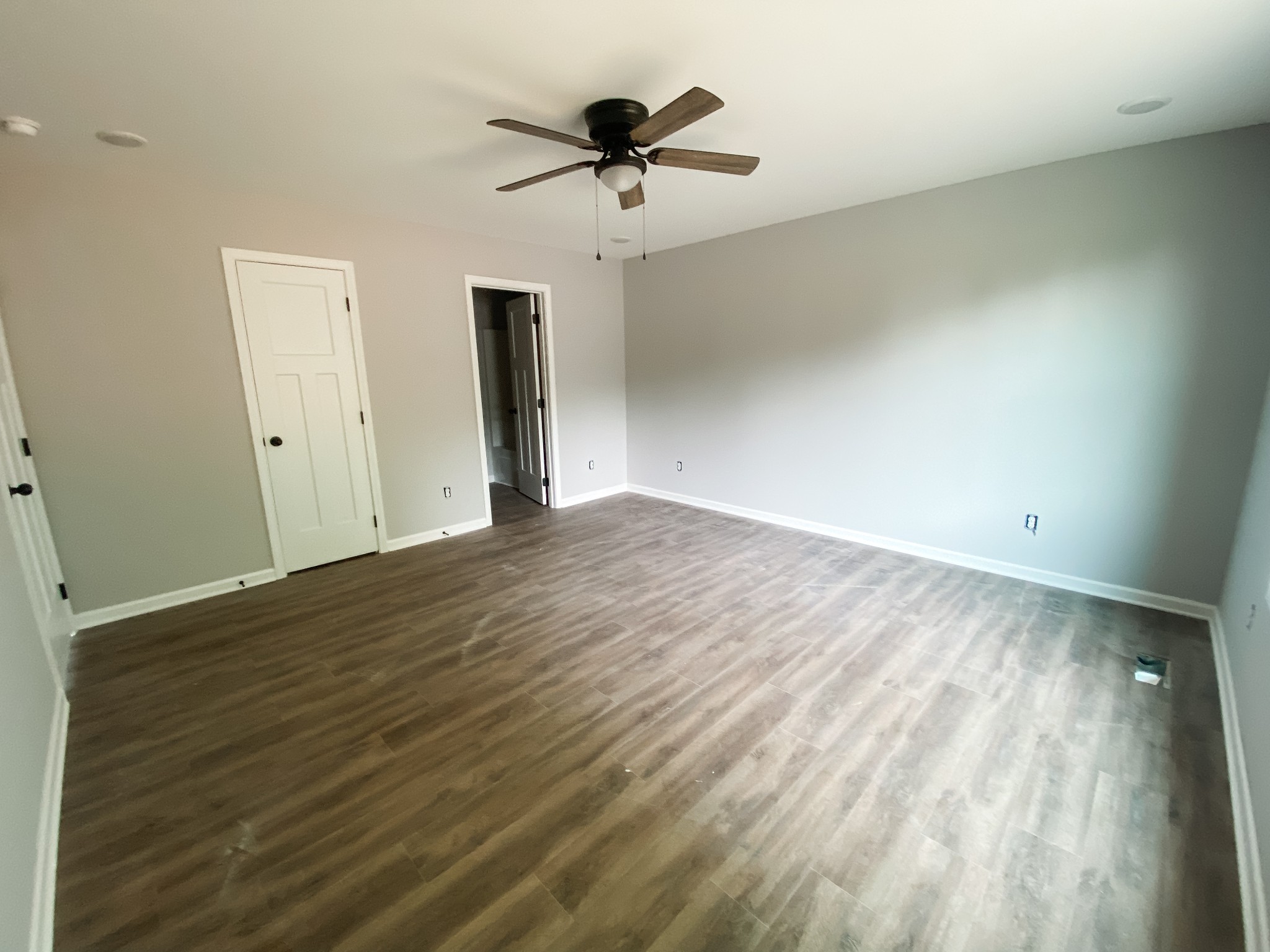 372 Calvert Ridge Road Westmoreland, TN 37186 - Photo 6 of 13 an empty room with wooden floor and ceiling fan