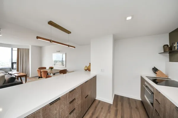 a kitchen with sink cabinets and wooden floor