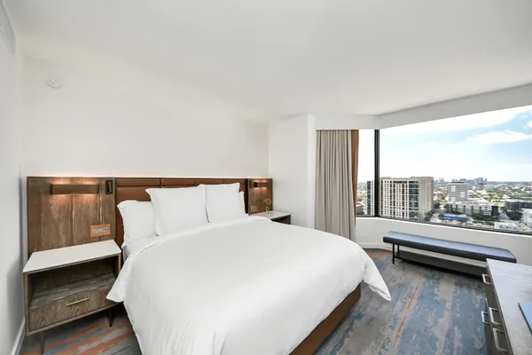 a bedroom with a bed and glass window