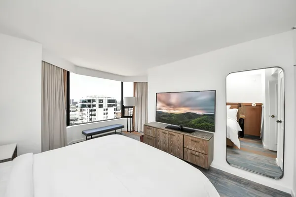 a bedroom with a bed and a flat screen tv