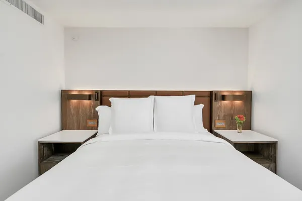 a bedroom with a bed and lamp