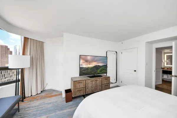 a bedroom with a bed and a flat screen tv