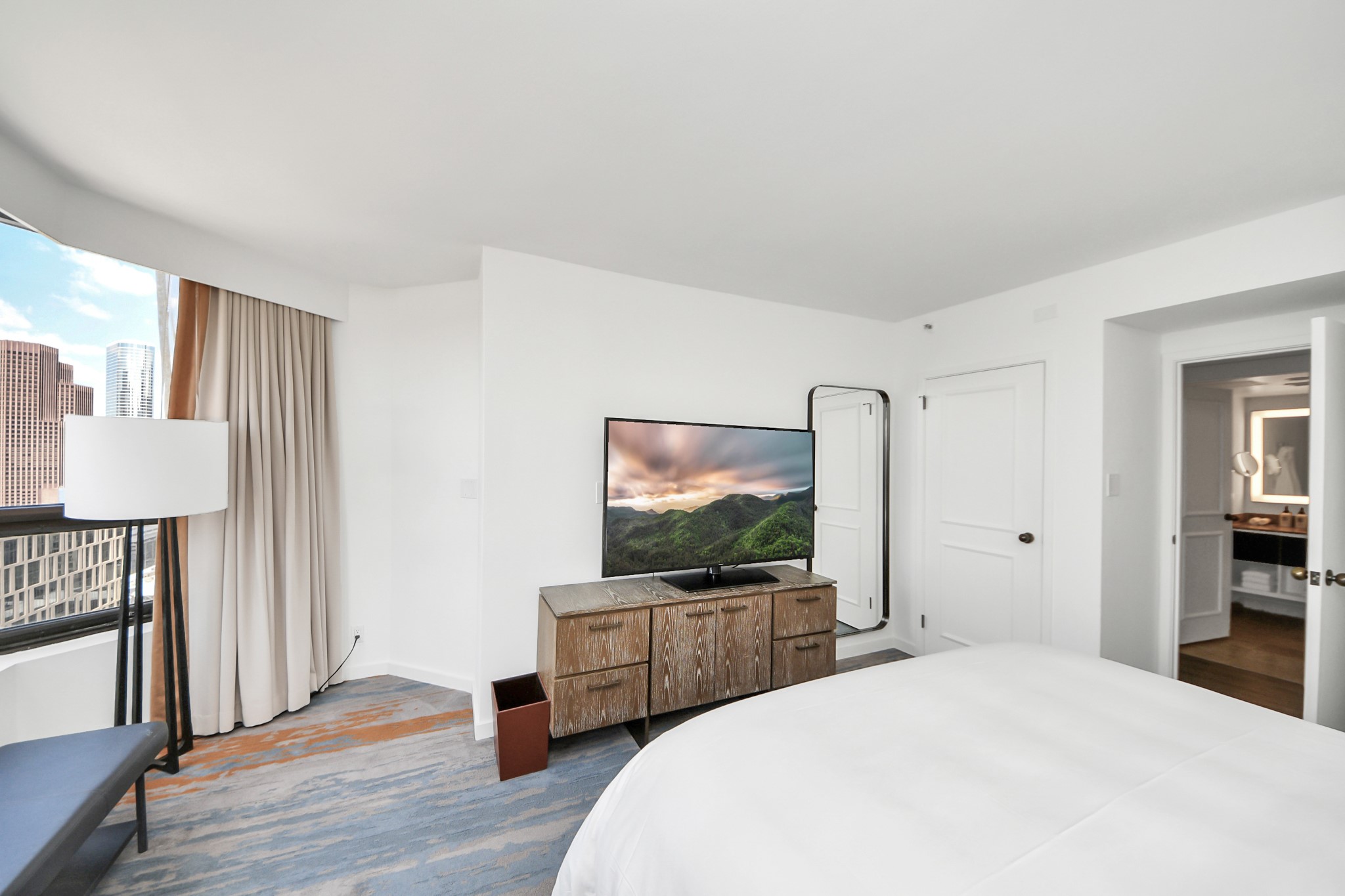 1300 Lamar Street, Unit S8 Houston, TX 77010 - Photo 26 of 50 a bedroom with a bed and a flat screen tv
