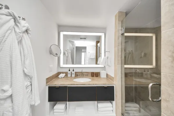 a bathroom with a tub sink and mirror