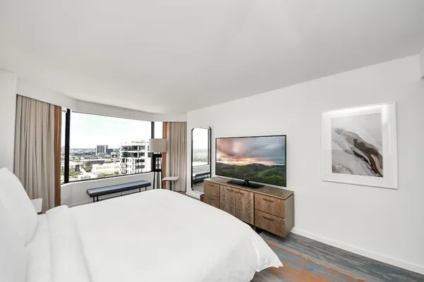 a bedroom with a bed and a flat screen tv