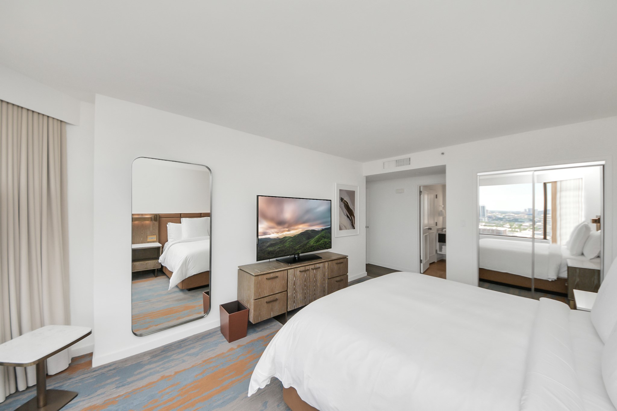 1300 Lamar Street, Unit S8 Houston, TX 77010 - Photo 35 of 50 a spacious bedroom with a bed and a flat screen tv