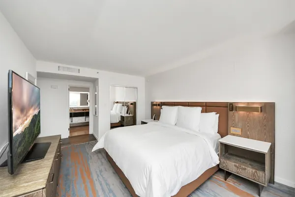 a bedroom with a bed and a flat screen tv