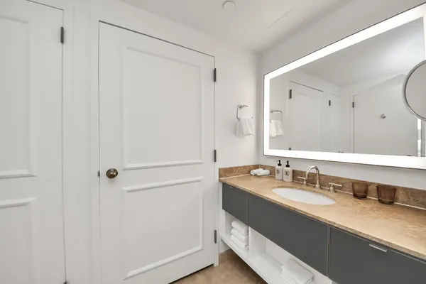 a bathroom with a double vanity sink and a mirror