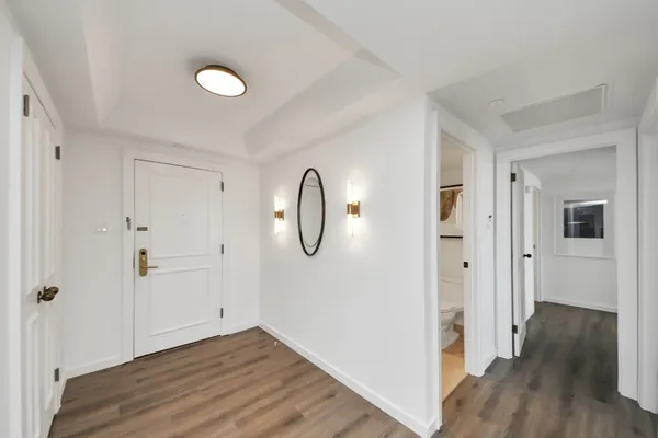a view of a room with wooden floor