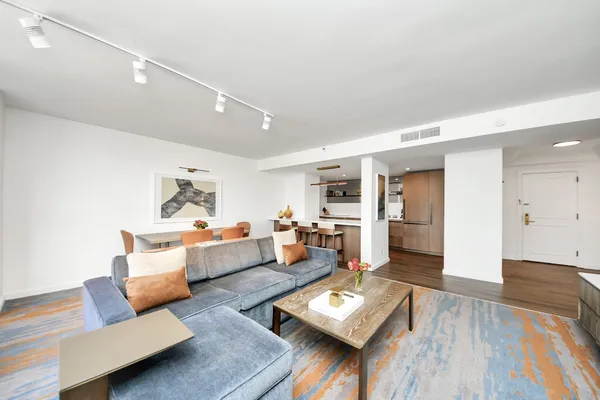 a living room with furniture and wooden floor