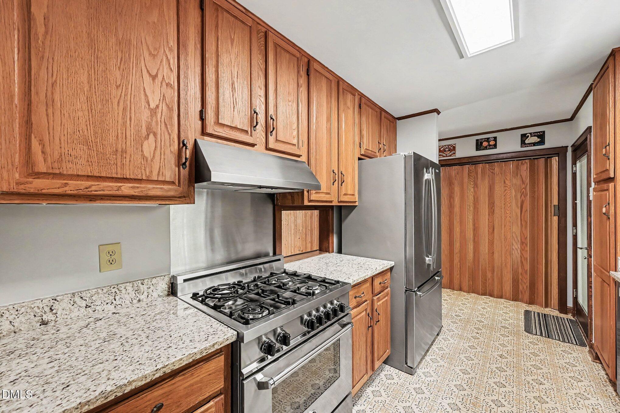 200 Spring Valley Road Carrboro, NC 27510 - Photo 15 of 38 a kitchen with a stove and a refrigerator