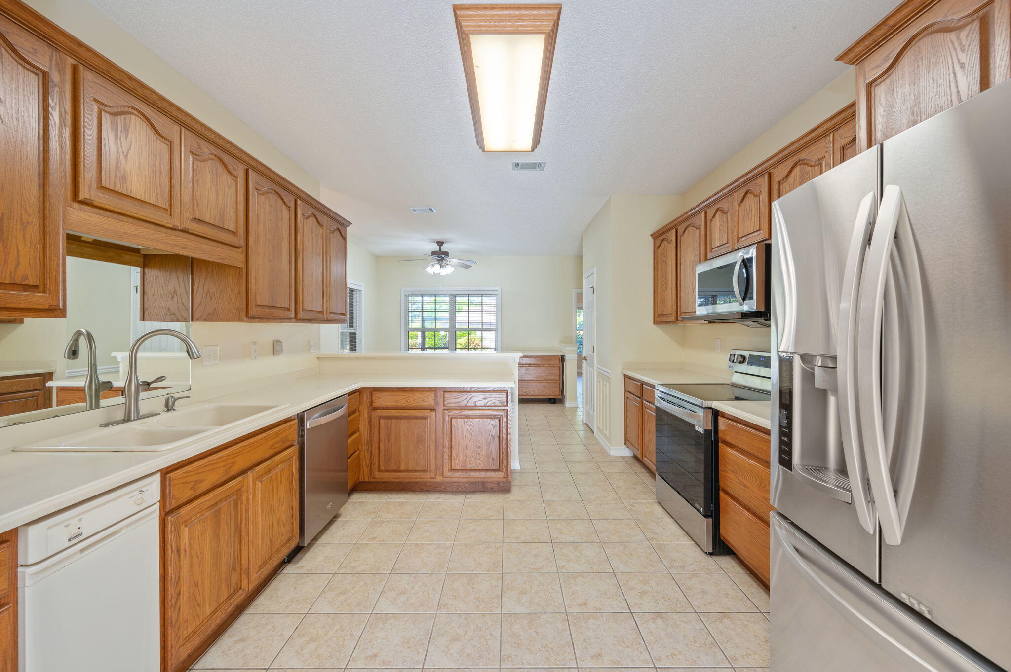 5552 Frontier Drive Crestview, FL 32536 - Photo 14 of 50 a large kitchen with stainless steel appliances granite countertop a refrigerator and a sink