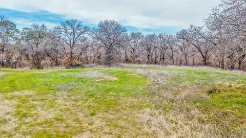 a backyard of a house with lots of green space and deers
