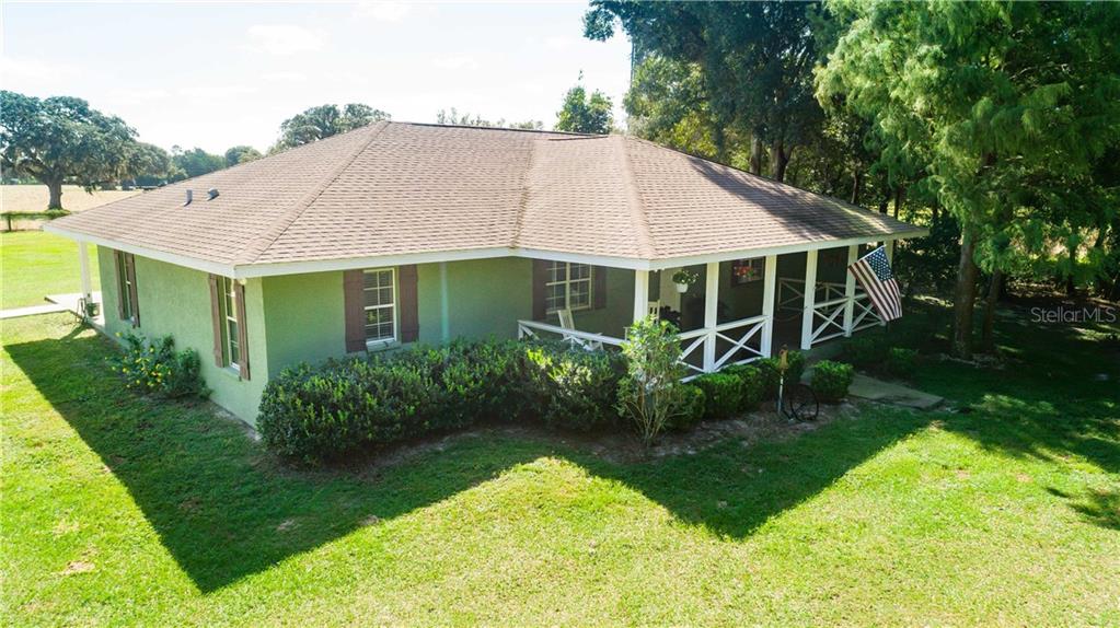 17333 Squirrel Prairie Road Brooksville, FL 34604 - Photo 1 of 1 a aerial view of a house with swimming pool next to a big yard