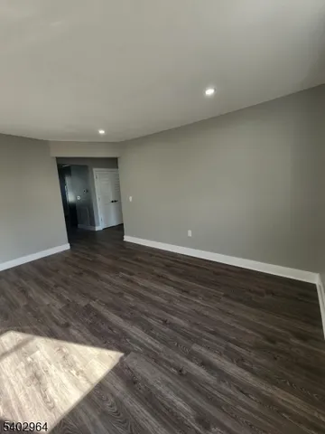 a view of a big room with wooden floor and natural light