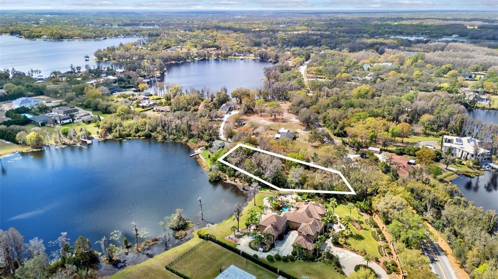 18709 Wayne Road Odessa, FL 33556 - Photo 33 of 34 an aerial view of a house with a lake view