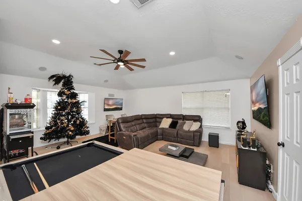 a living room with furniture potted plant and a window