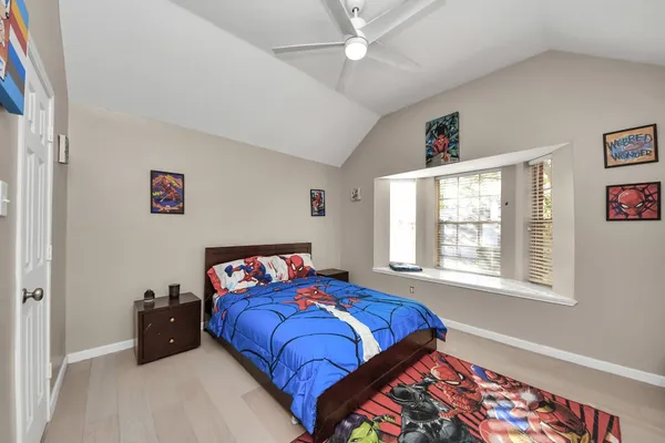 a bedroom with a bed and a window