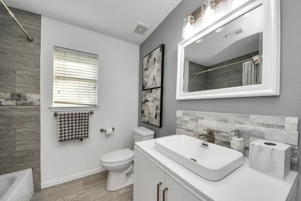 a bathroom with a sink toilet and shower