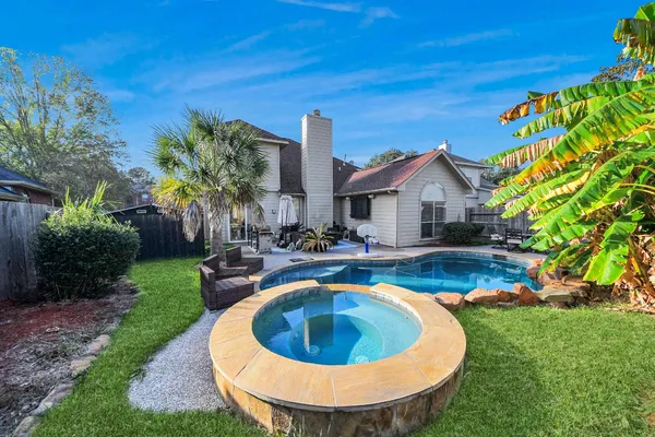 a view of a house with swimming pool and porch