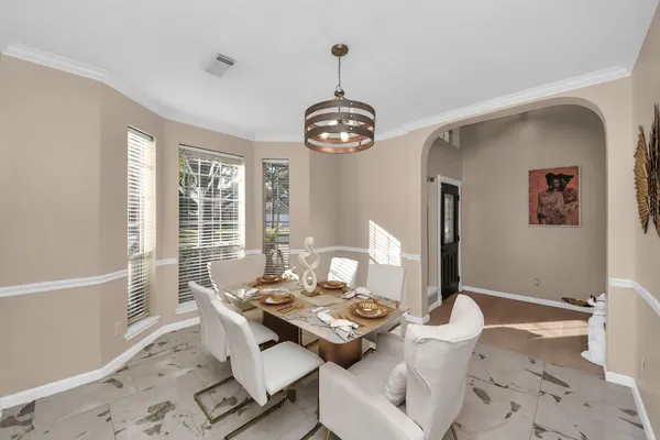 a view of a dining room with furniture window and wooden floor