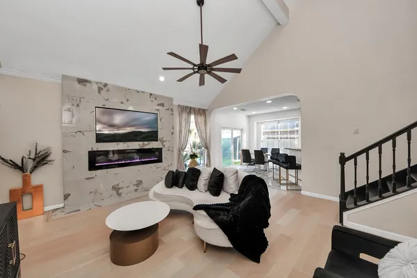 a living room with furniture a flat screen tv and white walls