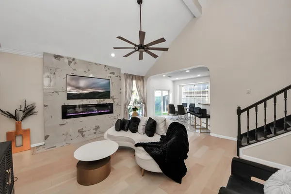 a living room with furniture a flat screen tv and a fireplace