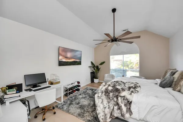a bedroom with a bed and a window
