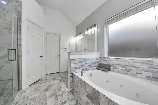 a bathroom with a bathtub and a sink