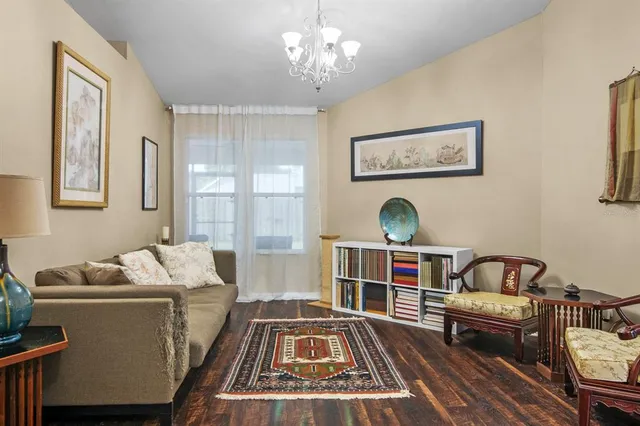 a bedroom with furniture and a wooden floor