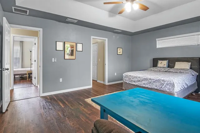 a bedroom with a bed and a chandelier