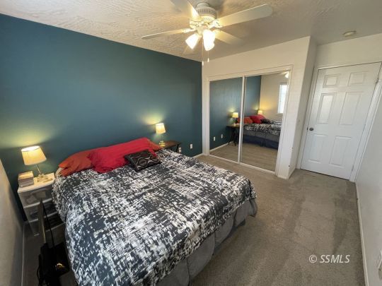1411 Sims Street Ridgecrest, CA 93555 - Photo 20 of 35 a bedroom with a bed and a mirror