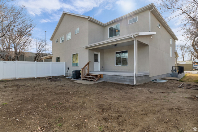 578 West 7th Midvale, UT 84047 - Photo 30 of 35 Back of house with stucco siding, a patio area, and a porch