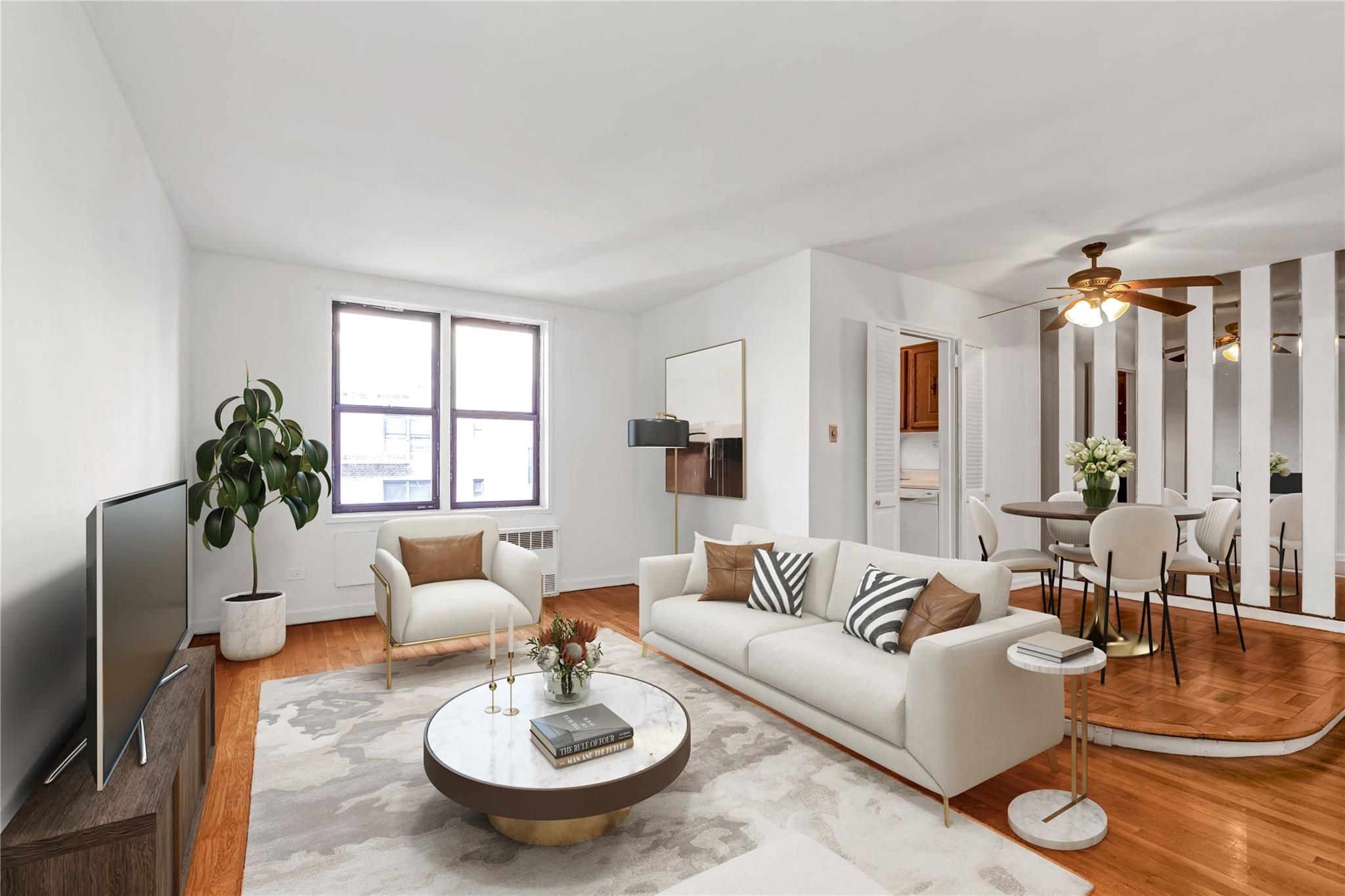 Living room featuring a ceiling fan, radiator heating unit, wood finished floors, and baseboards