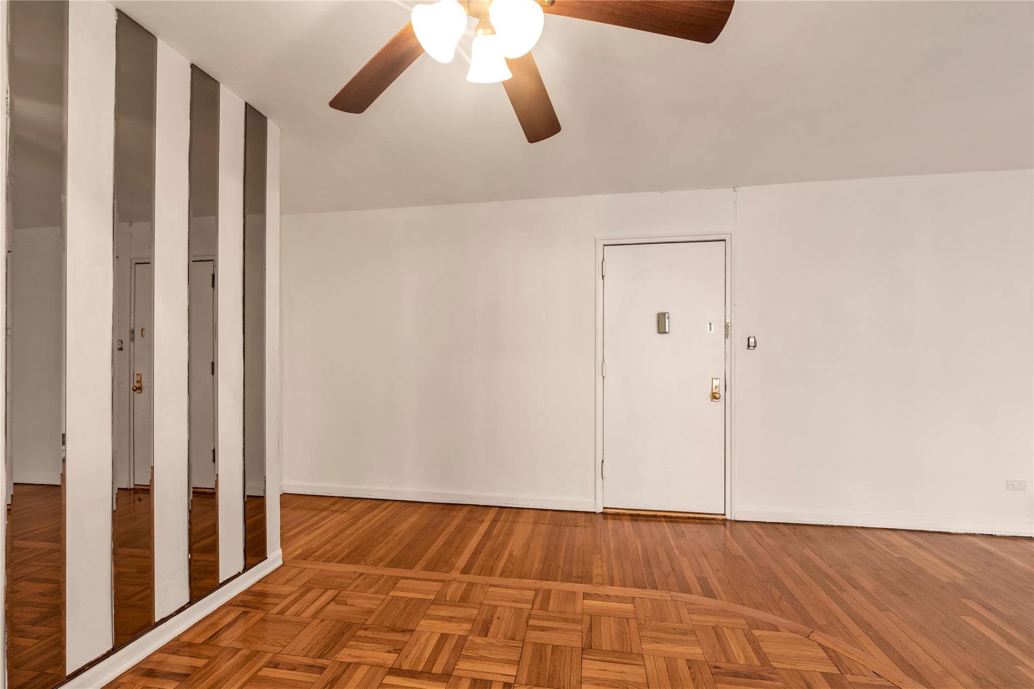 141-05 Pershing Crescent, Unit 210 Queens, NY 11435 - Photo 12 of 22 Unfurnished room featuring parquet flooring and ceiling fan
