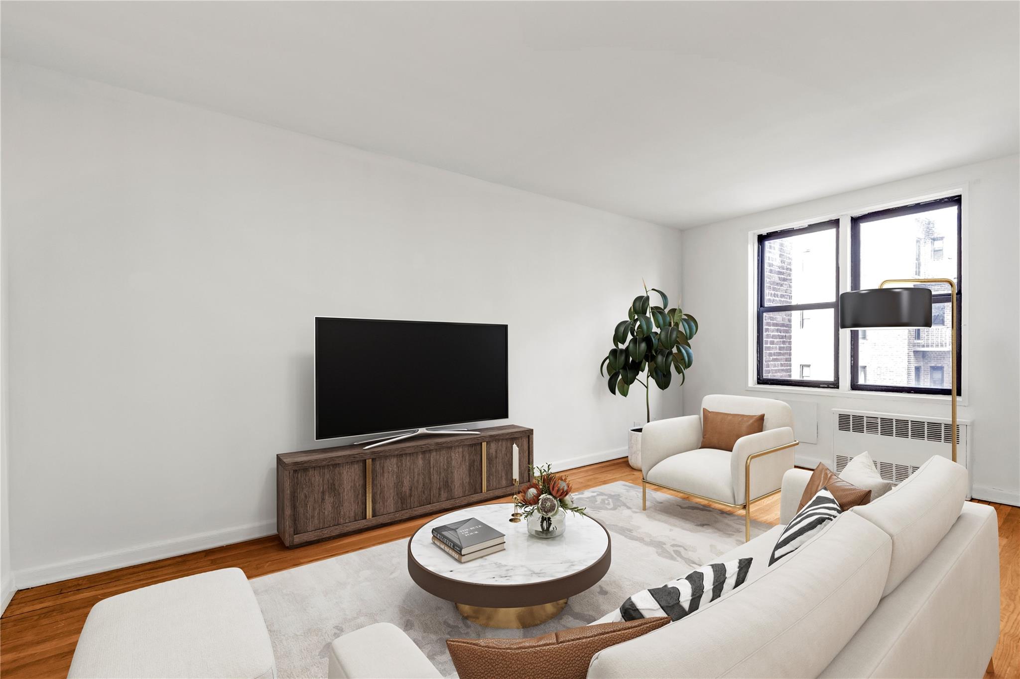 141-05 Pershing Crescent, Unit 210 Queens, NY 11435 - Photo 2 of 22 Living area featuring radiator heating unit, wood finished floors, and baseboards