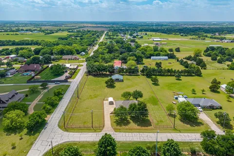 an aerial view of ocean with residential house swimming pool and outdoor space