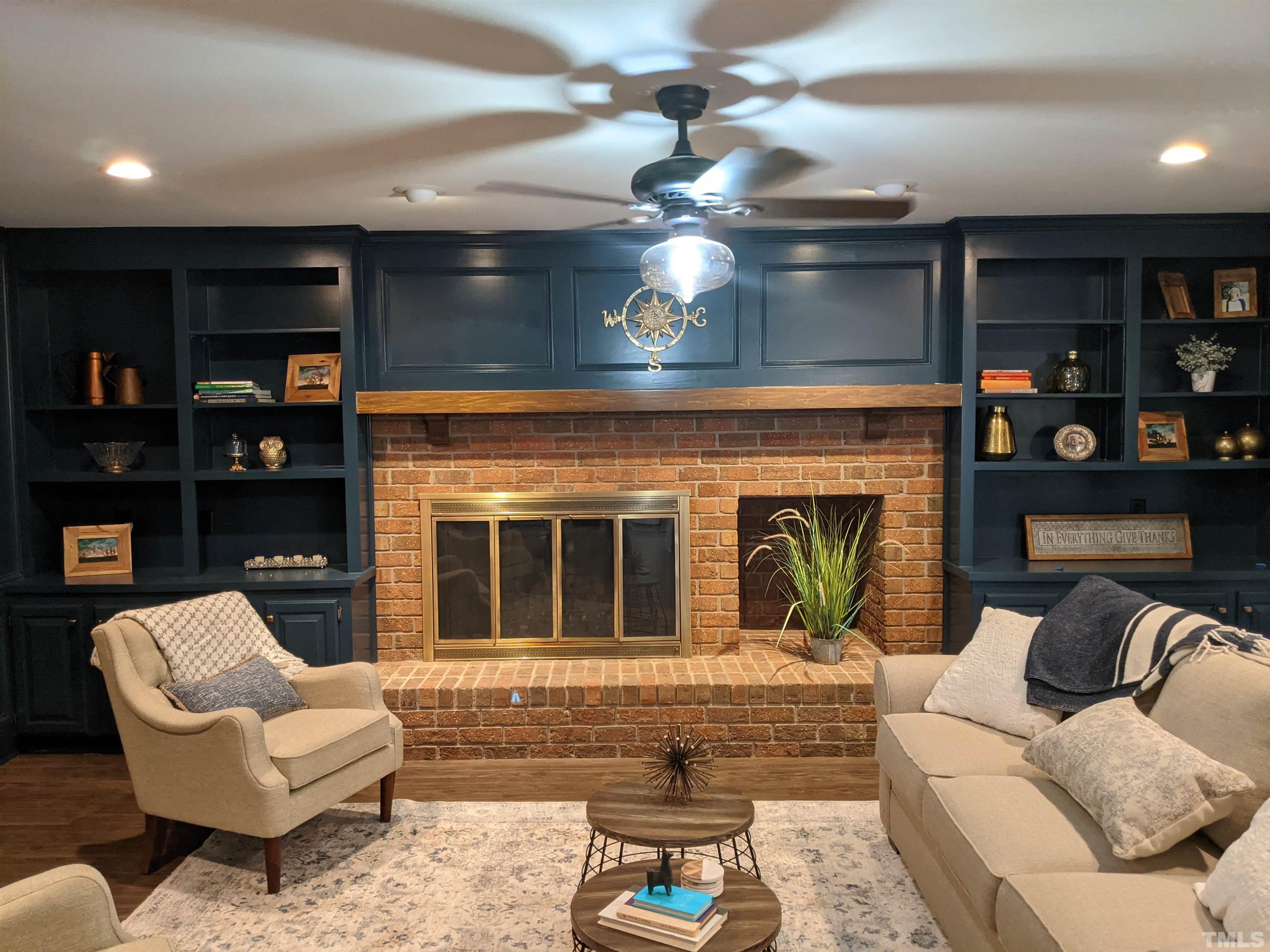 213 Trotters Ridge Drive Raleigh, NC 27614 - Photo 3 of 28 a living room with furniture a fireplace and a chandelier
