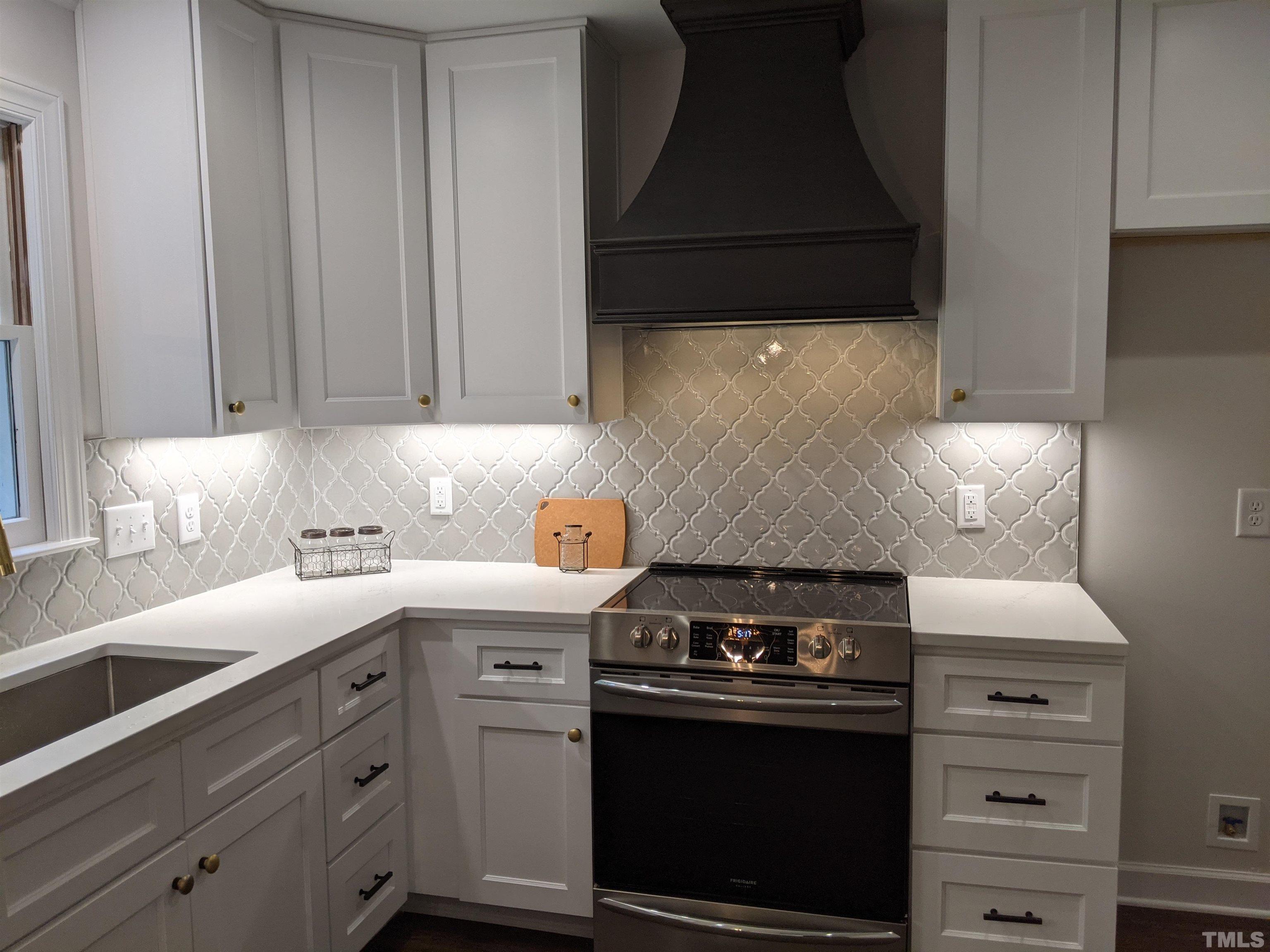 213 Trotters Ridge Drive Raleigh, NC 27614 - Photo 8 of 28 a kitchen with a stove and a cabinet