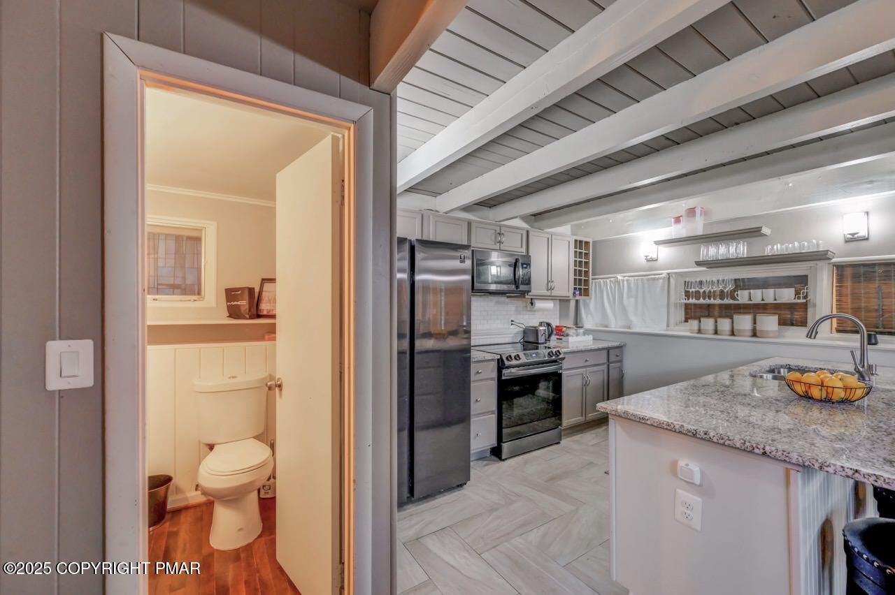 437 Westcolang Road Hawley, PA 18428 - Photo 17 of 108 a kitchen with stainless steel appliances granite countertop a refrigerator and a sink