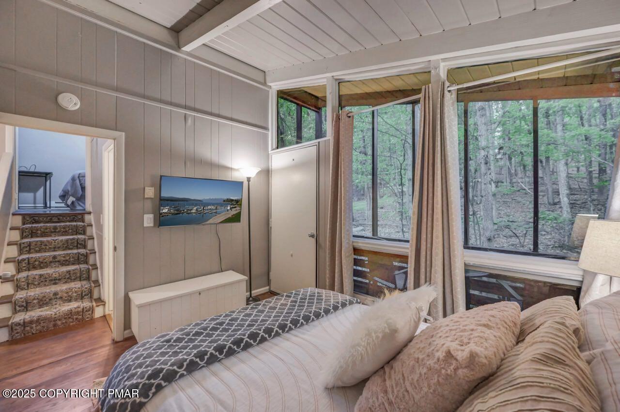 437 Westcolang Road Hawley, PA 18428 - Photo 27 of 108 a bedroom with a bed and glass windows