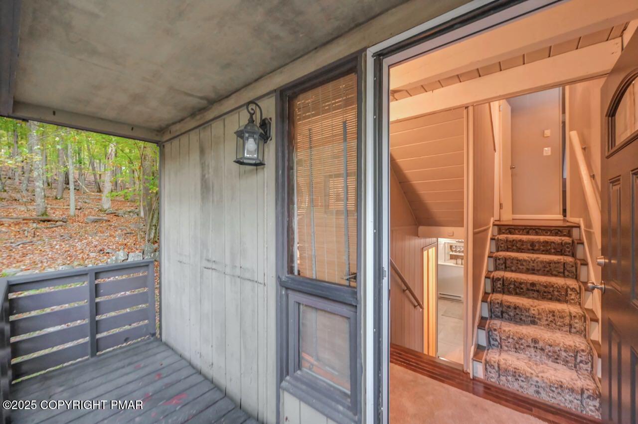 437 Westcolang Road Hawley, PA 18428 - Photo 31 of 108 a view of balcony with wooden floor and door