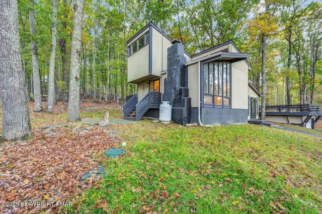 a view of outdoor space with deck and trees