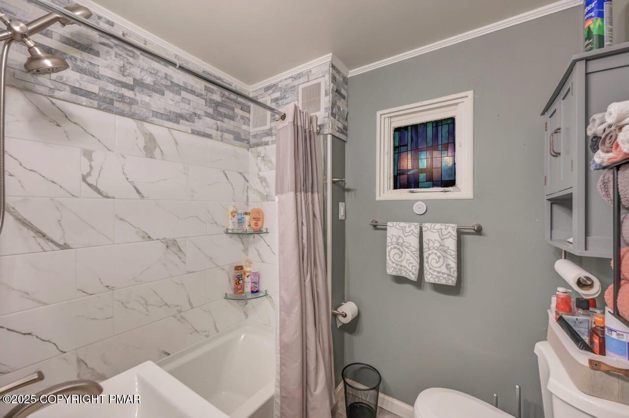 437 Westcolang Road Hawley, PA 18428 - Photo 64 of 108 a bathroom with a toilet sink and shower curtain