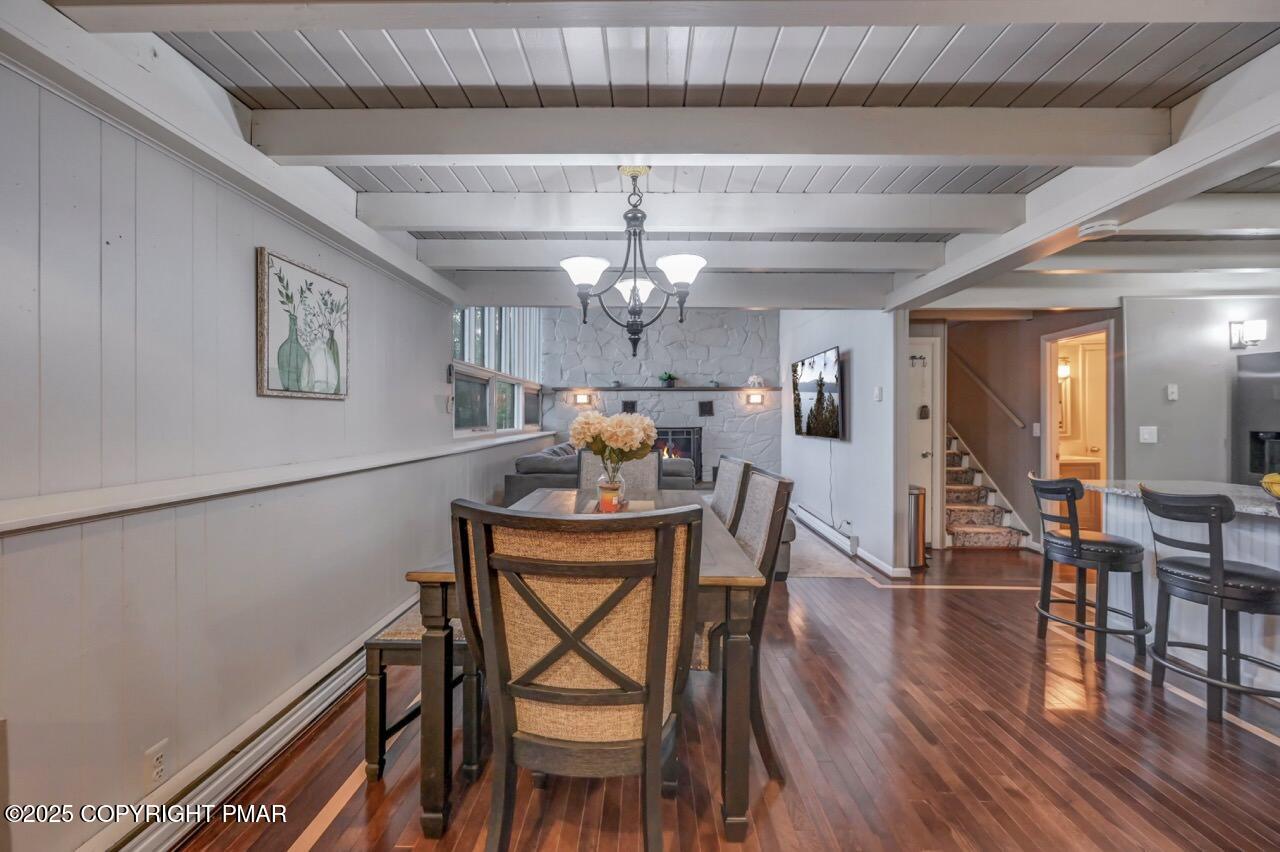 437 Westcolang Road Hawley, PA 18428 - Photo 7 of 108 a dining room with furniture wooden floor a rug and a painting
