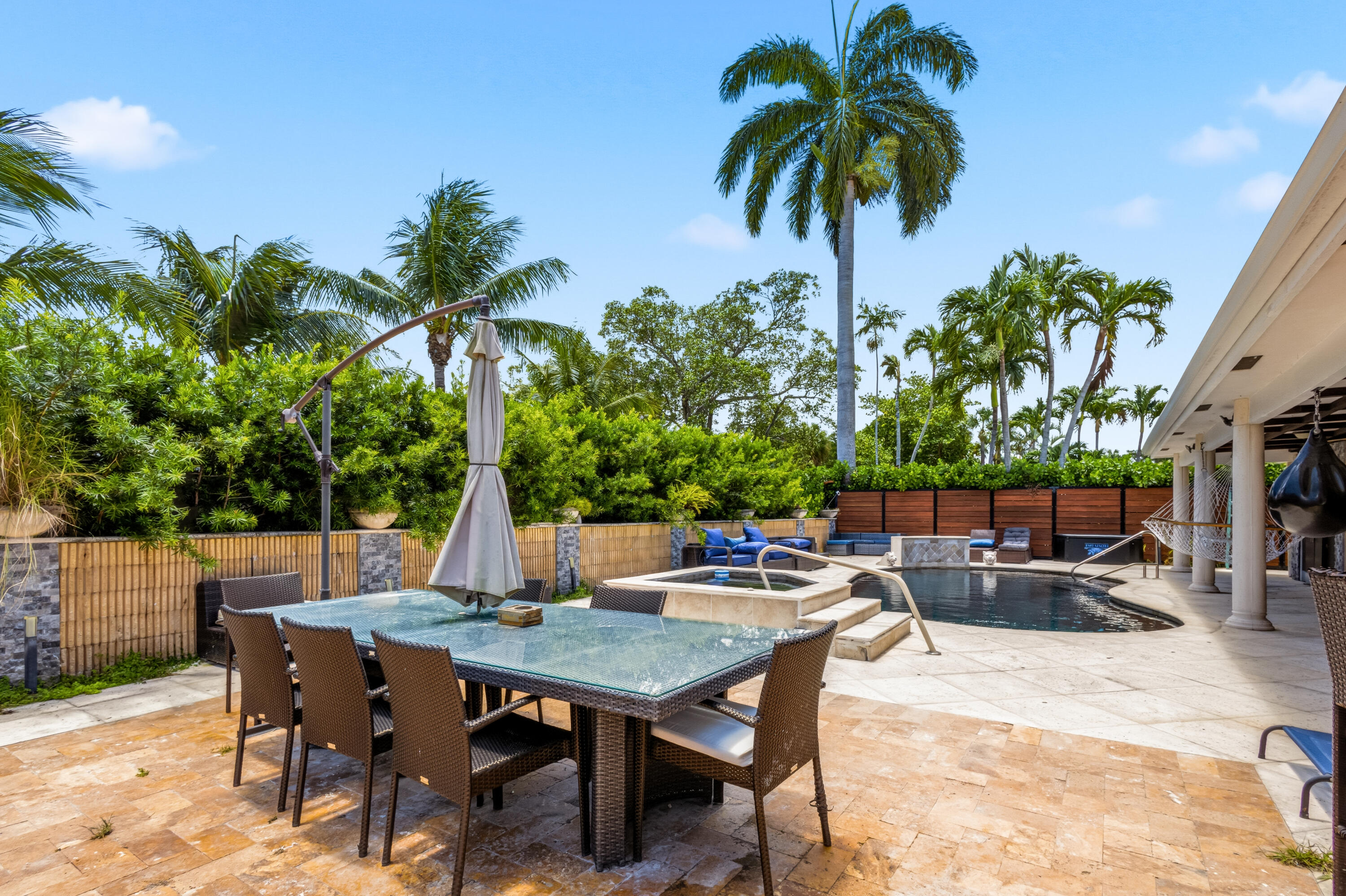 5223 Deerhurst Crescent Circle Boca Raton, FL 33486 - Photo 50 of 51 a view of a backyard with a patio table and chairs