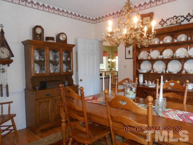 5404 Calverton Drive Raleigh, NC 27613 - Photo 3 of 25 a view of a dining room with furniture and chandelier