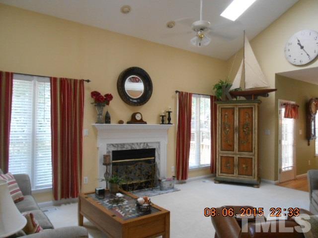 5404 Calverton Drive Raleigh, NC 27613 - Photo 5 of 25 a living room with furniture and a fireplace