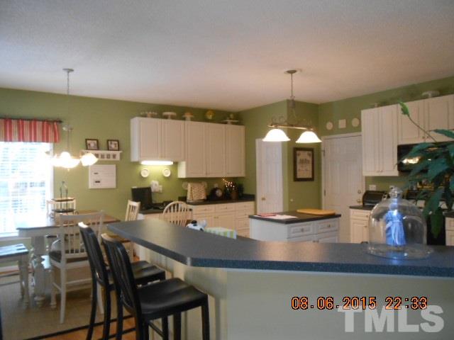 5404 Calverton Drive Raleigh, NC 27613 - Photo 7 of 25 a kitchen with a table and chairs in it